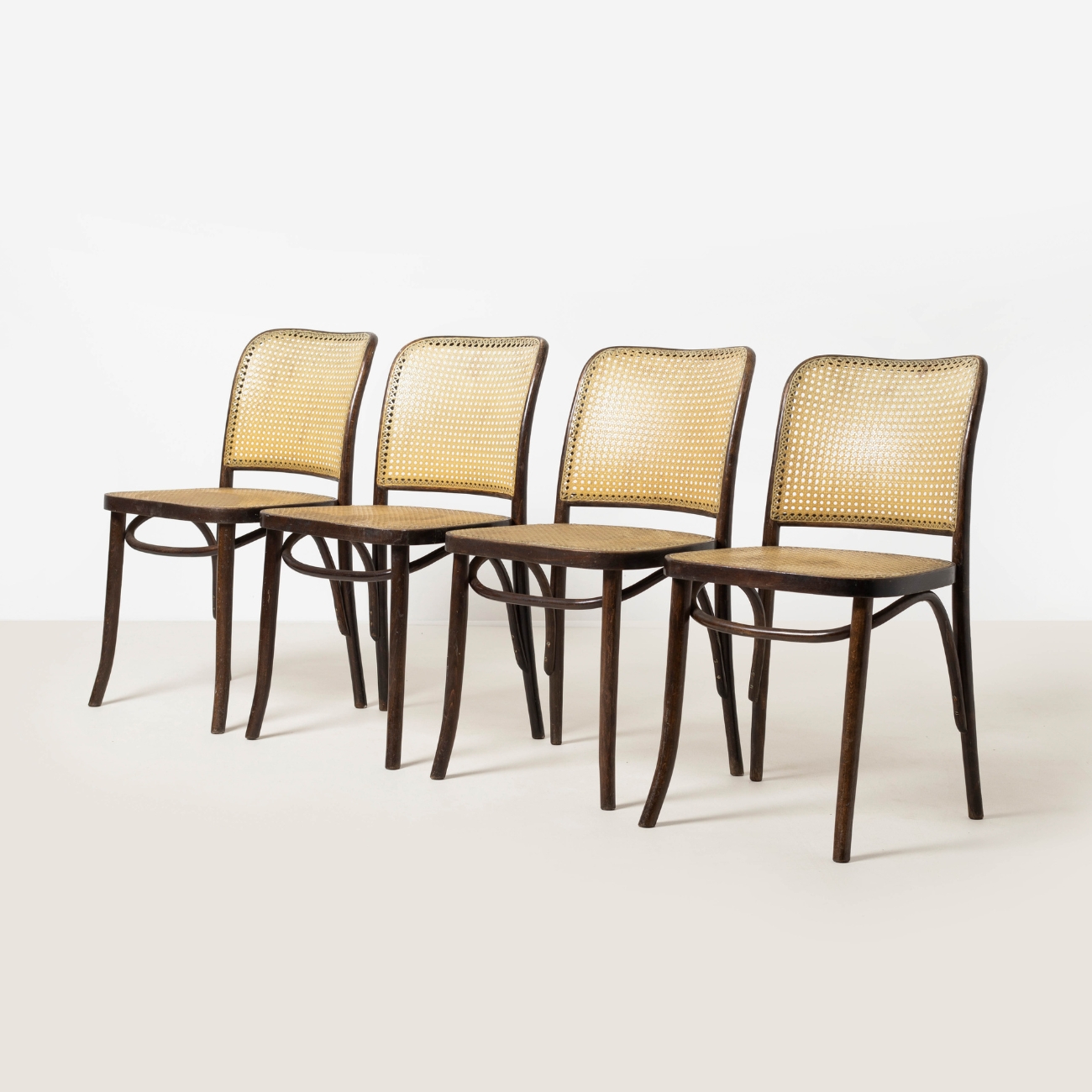 Front view of a bentwood Model 811 chair in dark stained beech with woven cane