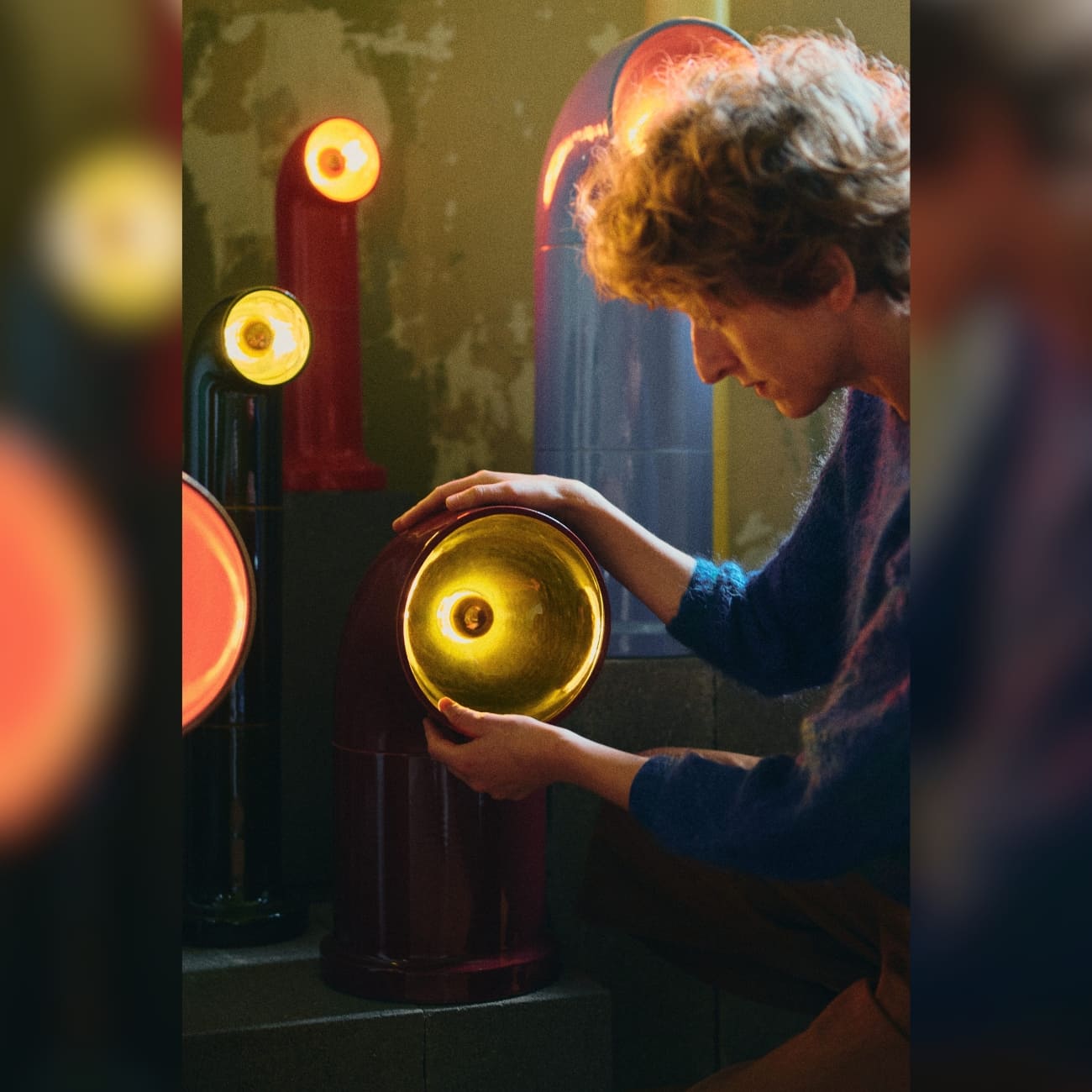 Pani Jurek working with handcrafted ceramic lamps from the TRN lighting series in her studio.