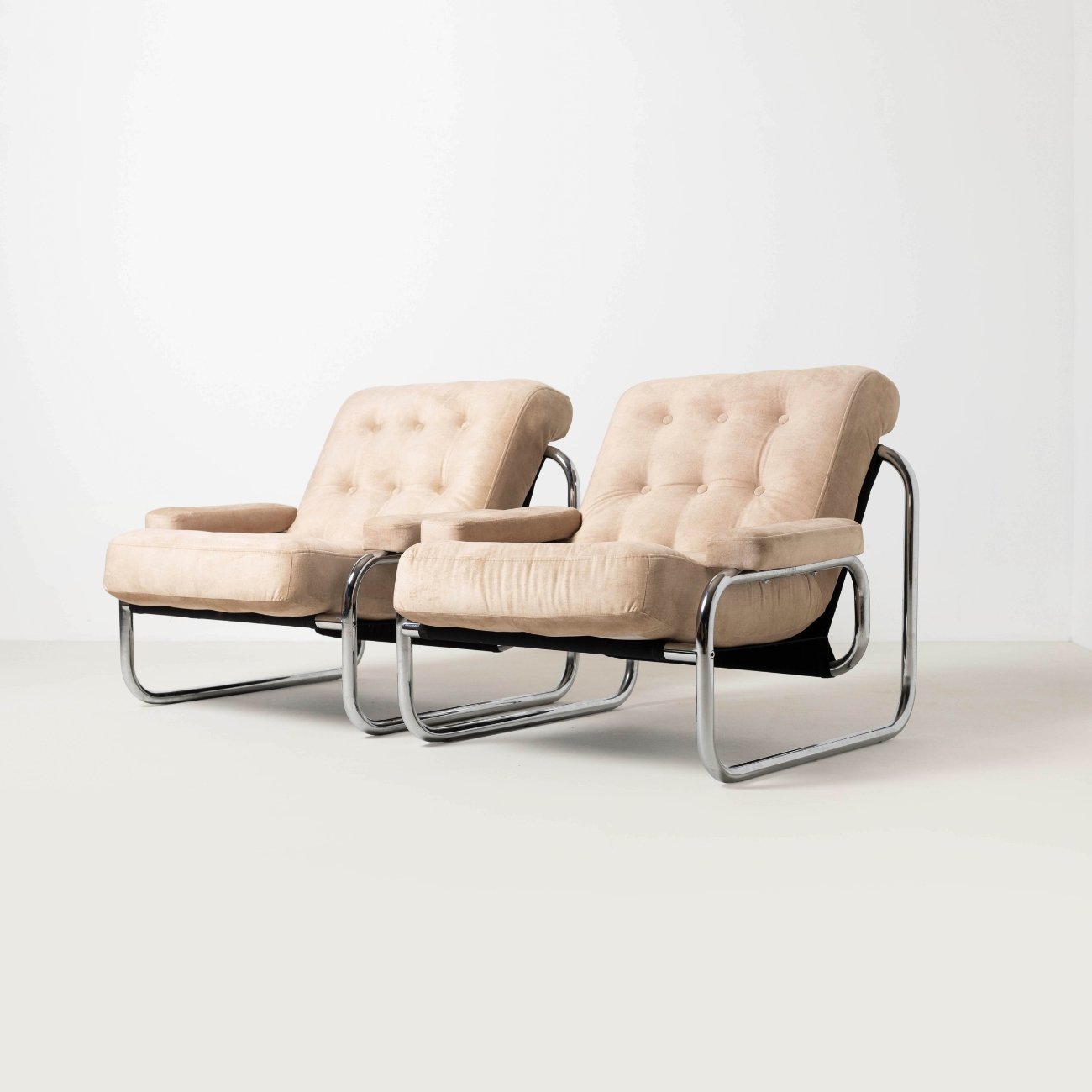 Pair of Borkum lounge chairs with new sand coloured cushions.
