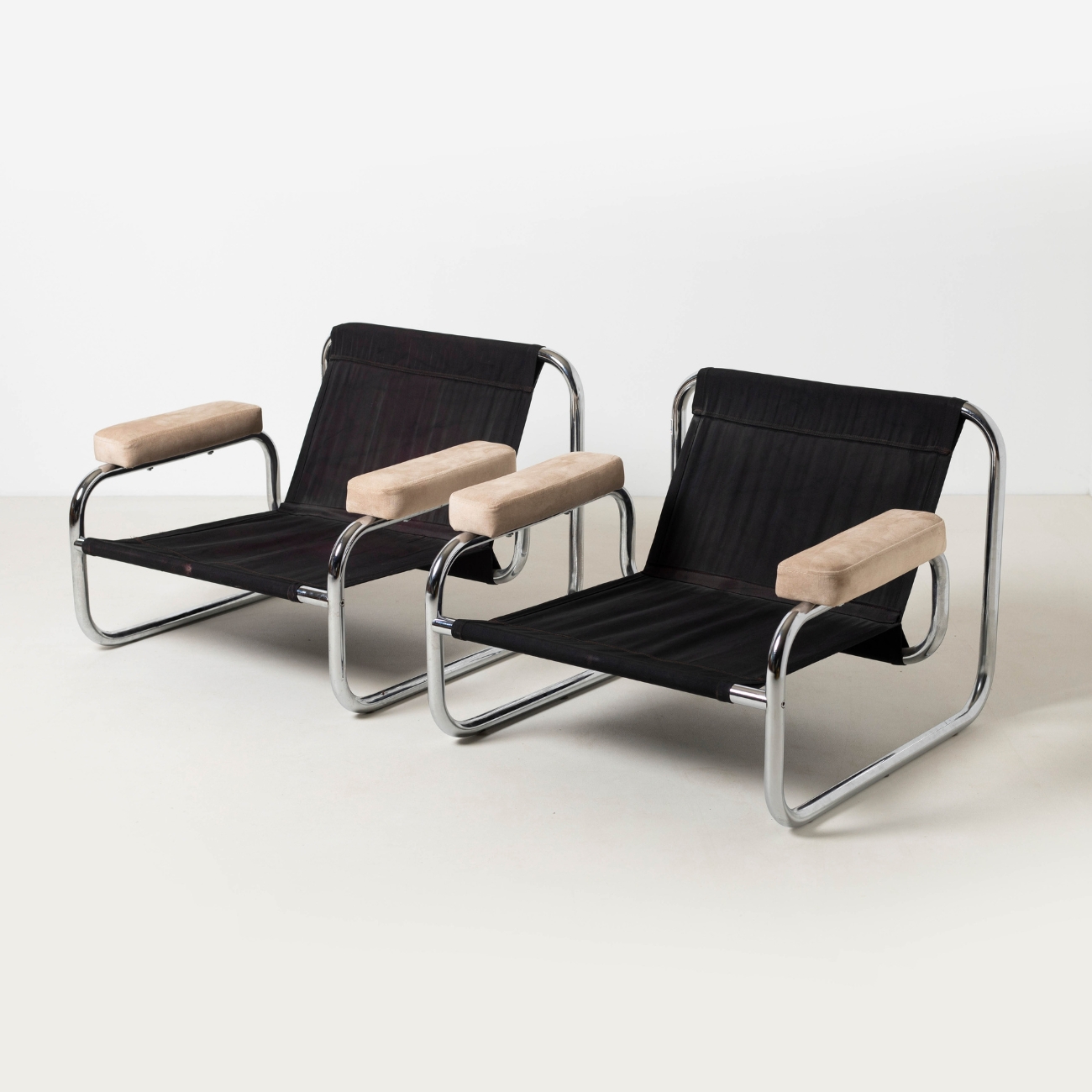 Borkum lounge chairs without cushions showing the chrome frame and original black suspension.