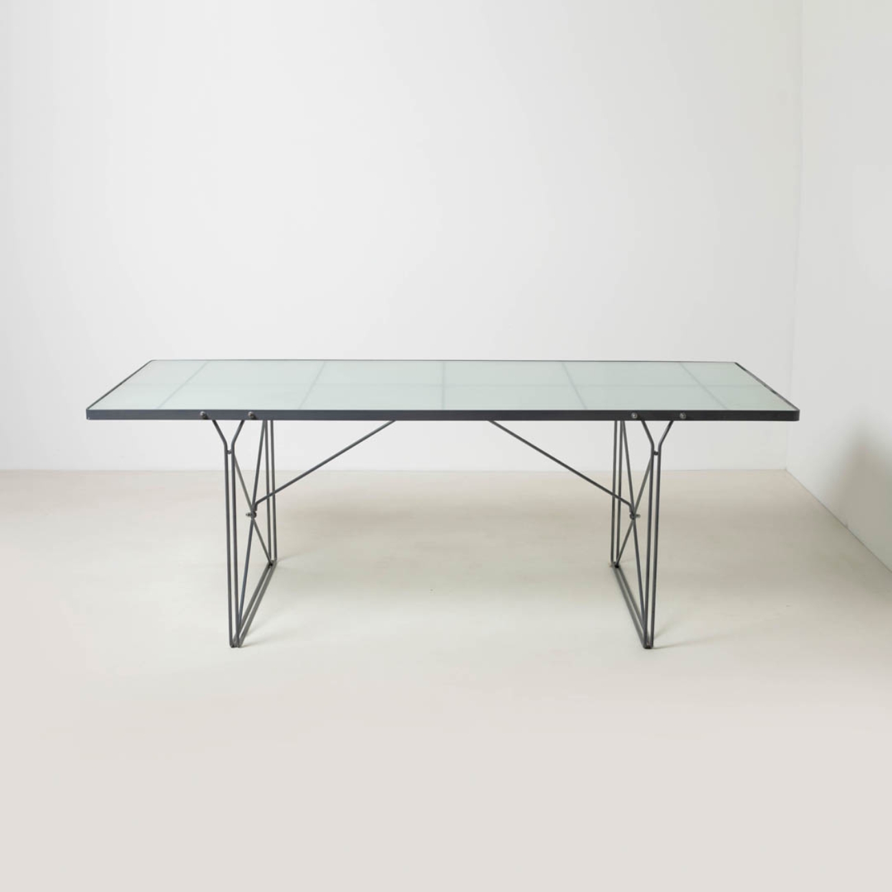 Front view of the IKEA Moment table with frosted glass top.