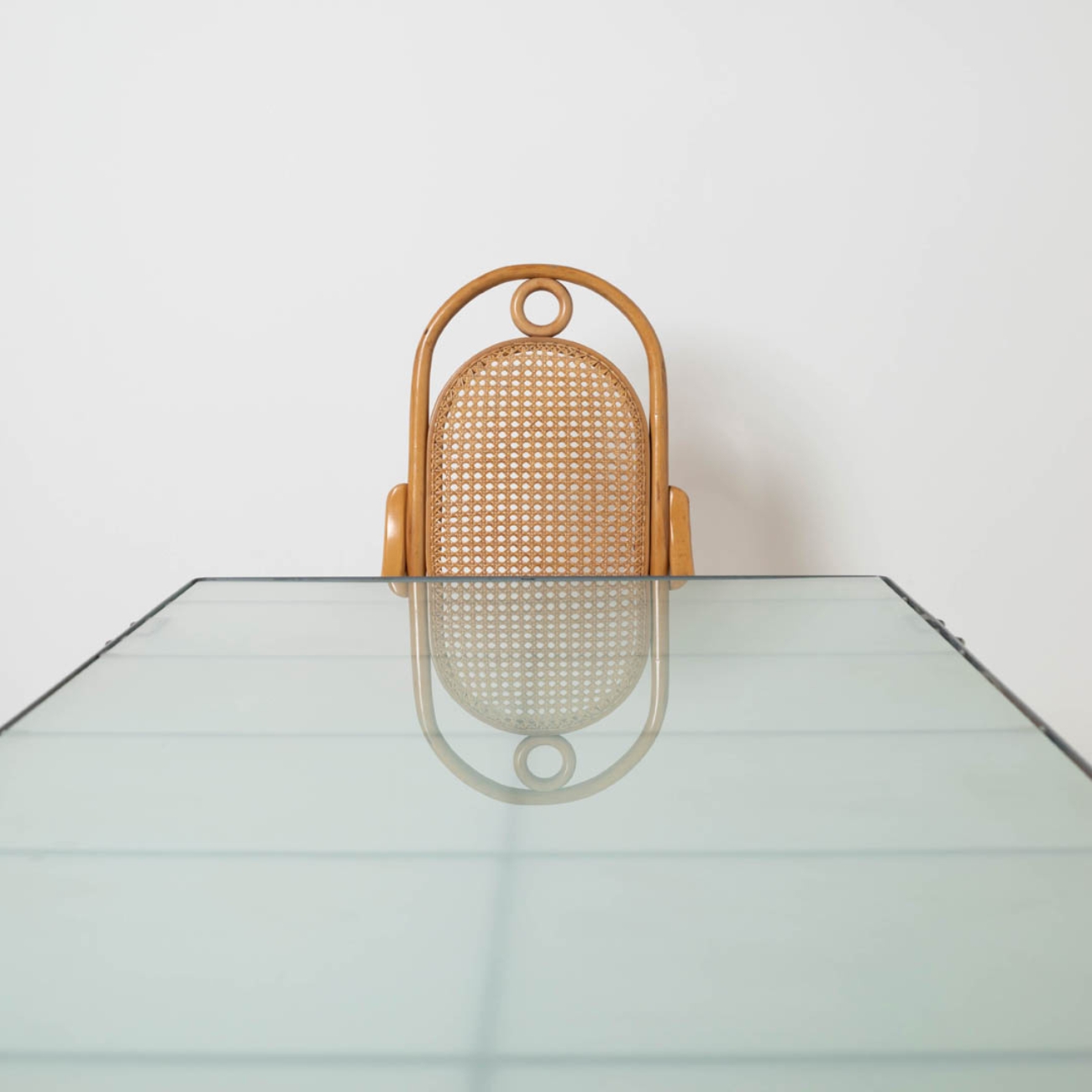 Frosted glass tabletop of the IKEA Moment table with chair in the background.