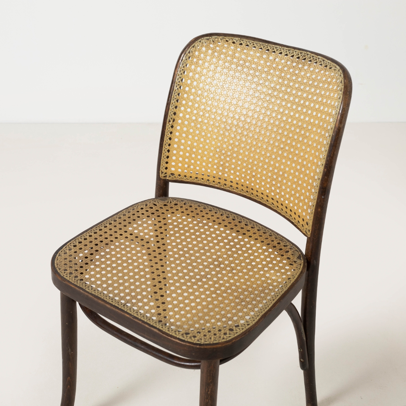 Close-up of the woven seat and backrest of a Josef Hoffmann Model 811 chair