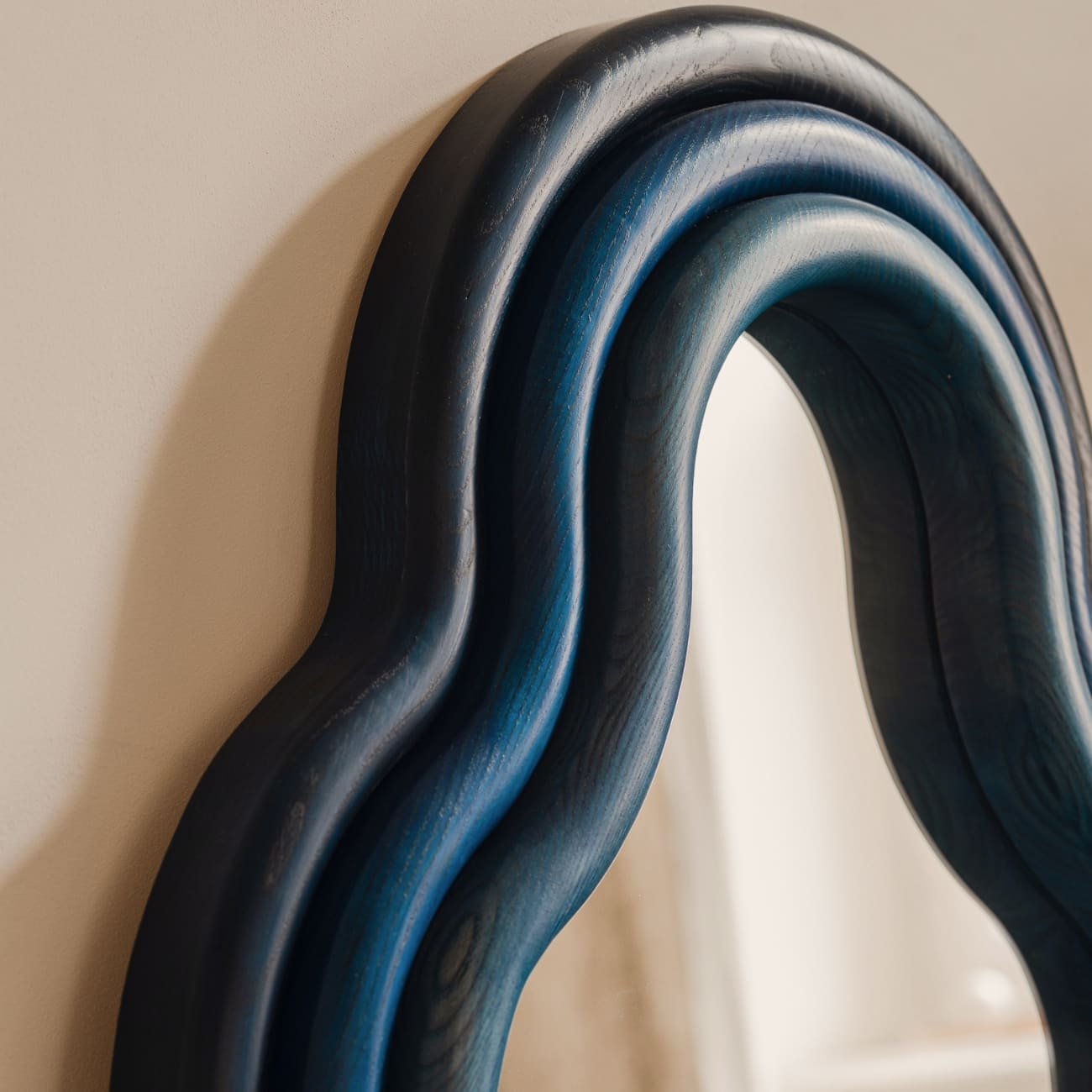 Contemporary sculptural wall mirror by Pani Jurek from the TRN collection, available at maybel, showcasing collectible design and artisan craftsmanship.