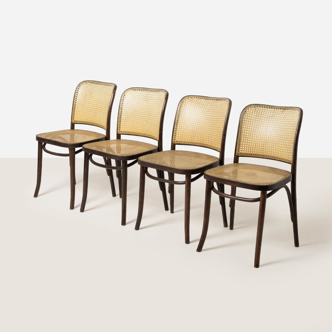 Four vintage Model 811 dining chairs shown from the front angle