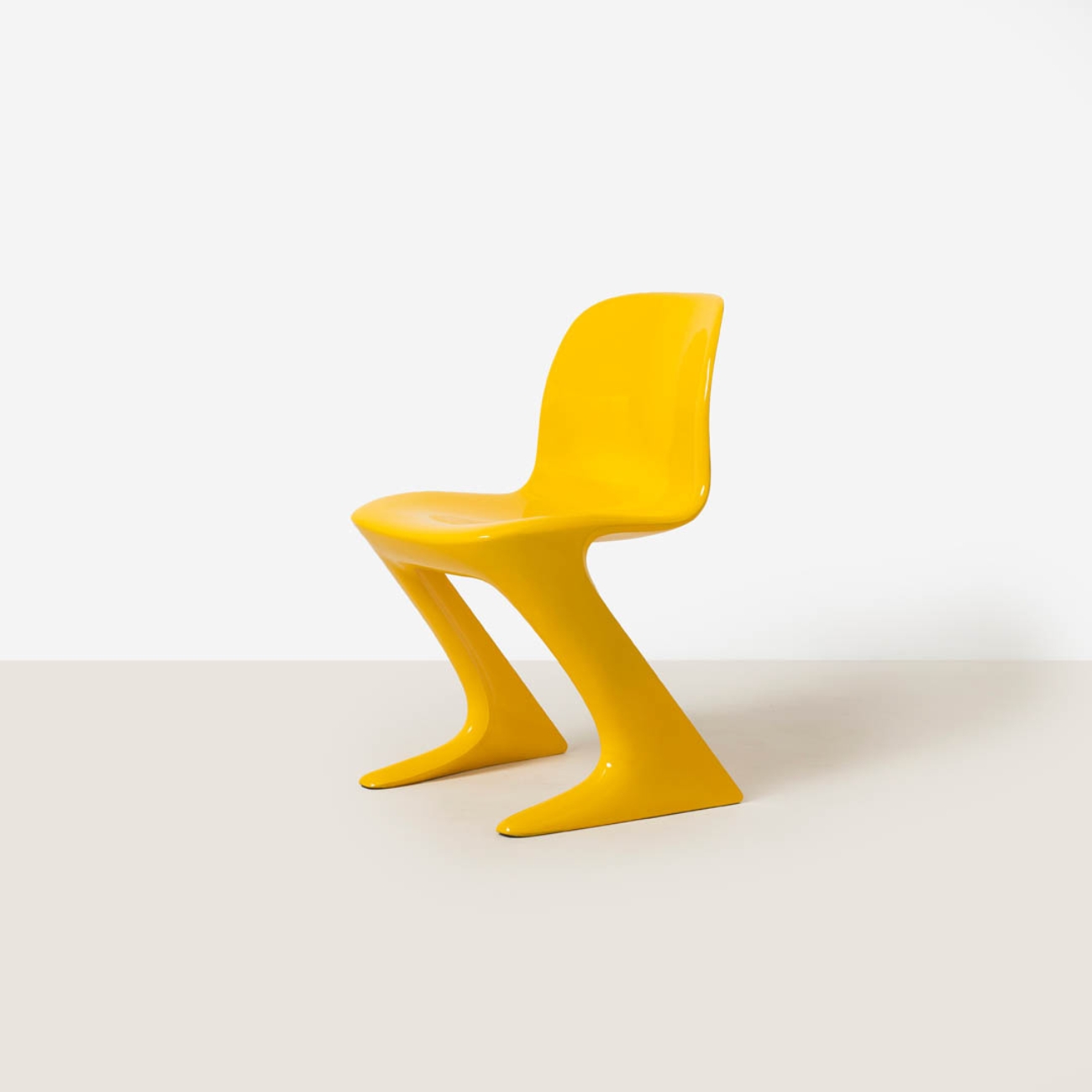 Single yellow Z-Stuhl chair shown from a front three-quarter angle against a neutral background.