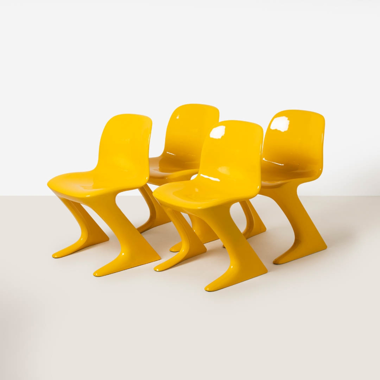 Set of four yellow Z-Stuhl chairs designed by Ernst Moeckl shown from the front against a neutral background.