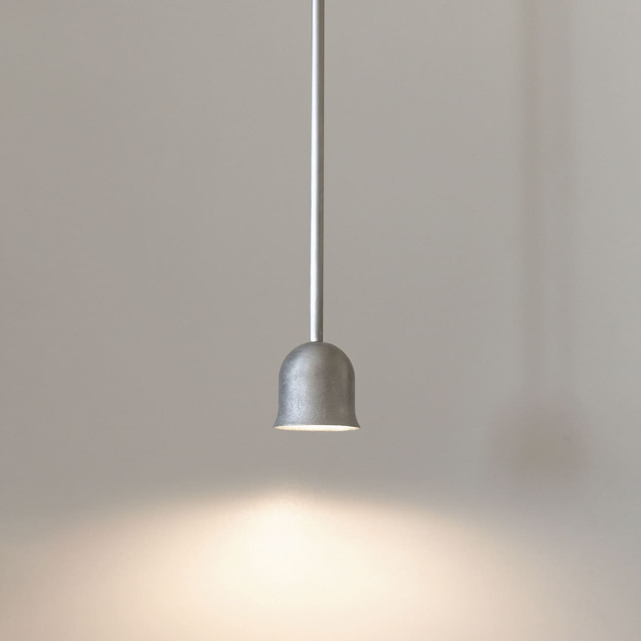 Lampa wisząca Convallaria z metalowym korpusem, pokazana podczas pracy z miękkim światłem skierowanym w dół.
